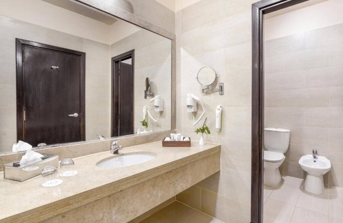 Village Road Resort | Bright & Airy Junior Suite – Lounge, Dressing Room, and Sparkling Pool Views