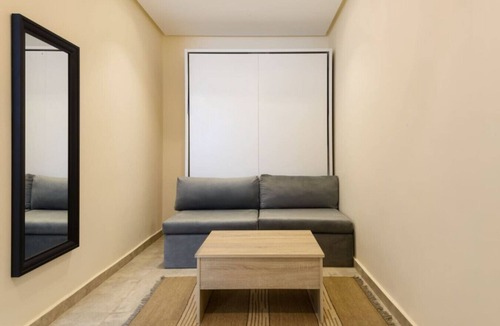 Cairo Apartment | Smart Compact Studio with Convertible Queen Bed , Sofa and Kitchenette and shared community garden