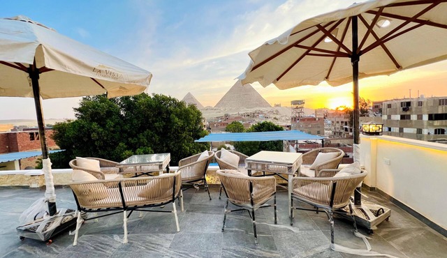 Watch the Great Pyramids of Giza glow at golden sunset from our rooftop terrace. in Giza Governorate