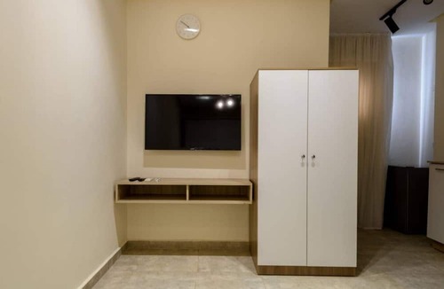 Cairo Apartment | Smart Compact Studio with Convertible Queen Bed , Sofa and Kitchenette and shared community garden