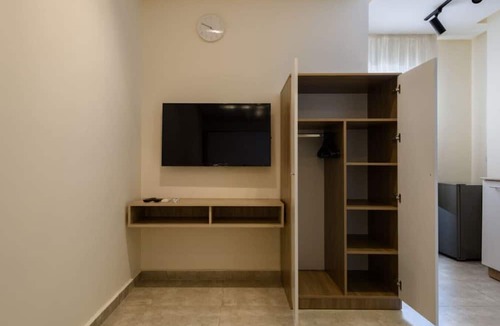 Cairo Apartment | Smart Compact Studio with Convertible Queen Bed , Sofa and Kitchenette and shared community garden